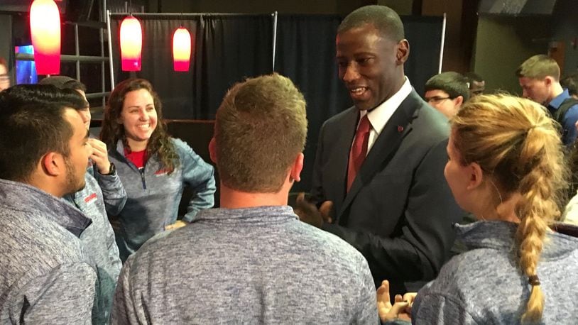 Dayton’s Anthony Grant talks to fans from the Red Scare student section on April 1, 2017, at UD Arena. David Jablonski/Staff