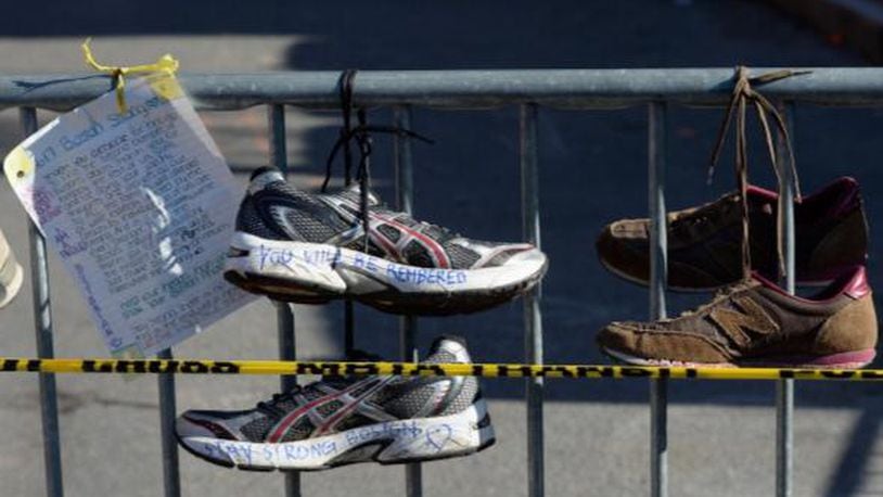 BOSTON, MA - APRIL 21:  Running shoes are placed at a makeshift memorial for victims near the finish line of the Boston Marathon bombings at the intersection of Newbury Street and Darthmouth Street two days after the second suspect was captured  on April 21, 2013 in Boston, Massachusetts. A manhunt for Dzhokhar A. Tsarnaev, 19, a suspect in the Boston Marathon bombing ended after he was apprehended on a boat parked on a residential property in Watertown, Massachusetts. His brother Tamerlan Tsarnaev, 26, the other suspect, was shot and killed after a car chase and shootout with police. The bombing, on April 15 at the finish line of the marathon, killed three people and wounded at least 170.  (Photo by Kevork Djansezian/Getty Images)