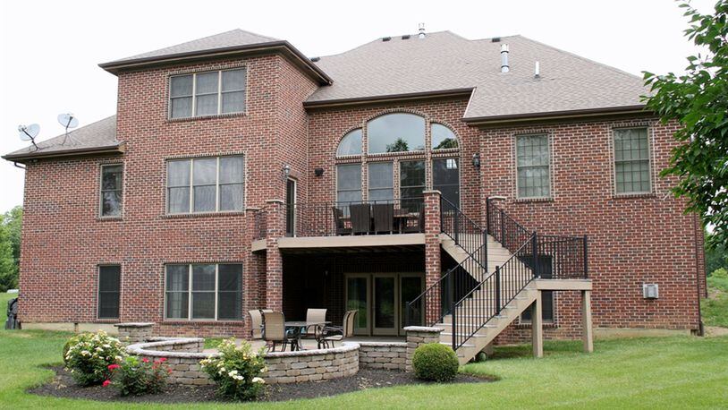 The balcony deck is accessible from the breakfast room and the first-floor main bedroom. The finished lower level walks out to a paver-brick patio and a fountain. There is a bonus room above the 3-car garage.
