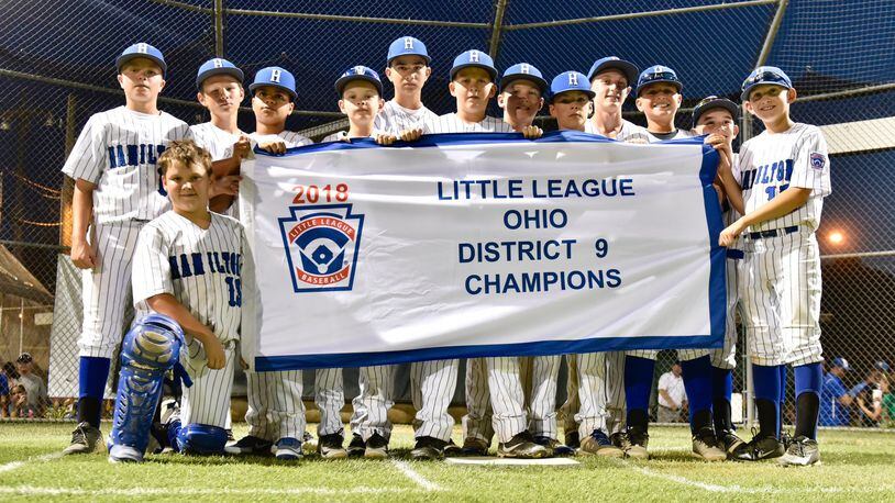 Hamilton West Side’s players pose for a photo Thursday night after winning the Little League District 9 tournament championship with a 15-0 victory over Hamilton-Fairfield at West Side. NICK GRAHAM/STAFF