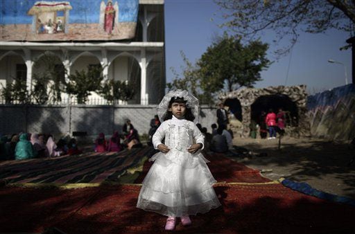 Pakistani Anusha Khalid, 4, dressed as a bride, poses for a picture at an outdoor Mass on Christmas Day in Pakistan.
