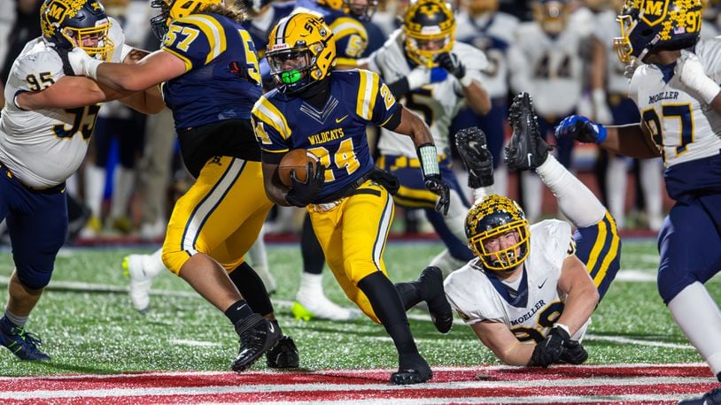 Springfield's Deontre Long looks for room to run vs. Moeller in the state semifinals at Piqua on Nov. 24, 2023.. Michael Cooper/CONTRIBUTED