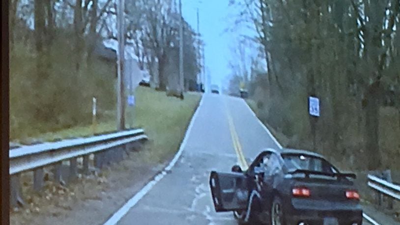 Police cruiser camera footage from a confrontation with Aaron Mitchell, who is being held on charges related to shots fired at the Clay Twp. administration building and a chase.