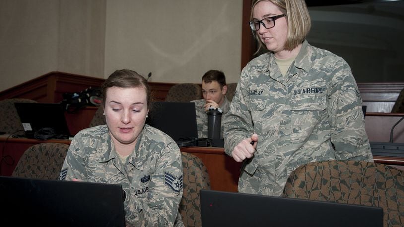 Staff Sgt. Amanda Morgan, Cybersecurity Foundry Course student, receives assistance from Airman 1st Class Shelby McKinlay, a CFC instructor, at MacDill Air Force Base, Fla., March 9. Course instructors taught 100 cyberspace students various cybersecurity functions, processes, procedures and data analysis skills to further their ability to secure the Air Force Network. (U.S. Air Force photo/Senior Airman Mariette Adams)