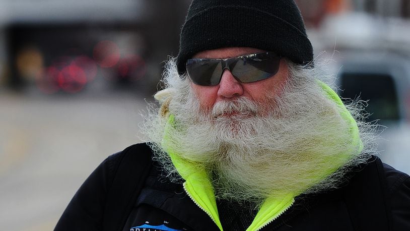 The beard of John K. Berger gets blowed around as he walks near downtown Dayton on a windy Thursday afternoon Feb. 9, 2023. MARSHALL GORBY\STAFF