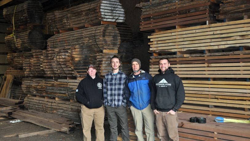 Staff from Moraine based Outdoor Living Group stand in front of processed lumber. The company’s sawmill operation helped people clean up their yards after last year’s tornadoes. L-R Chris Trembley, Jake Kingery, Tony Niekamp, Barrett Niekamp CONTRIBUTED