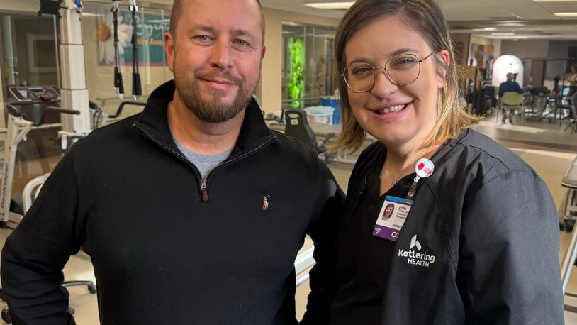 Pictured is Bill Wooley, a former Kettering Health Hamilton patient patient who sustained a severe spinal cord injury after an accident, with occupational therapy Erin Mueller, a member of his care team who helped him through his recovery efforts. MICHAEL D. PITMAN/STAFF