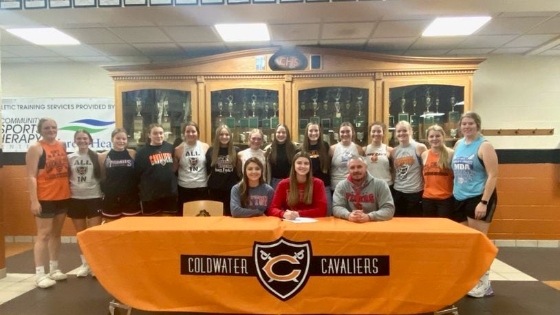 Coldwater seniro Riley Rismiller signs her national letter of intent with Dayton women's basketball on Monday, Nov. 14, 2022 Photo courtesy of Coldwater