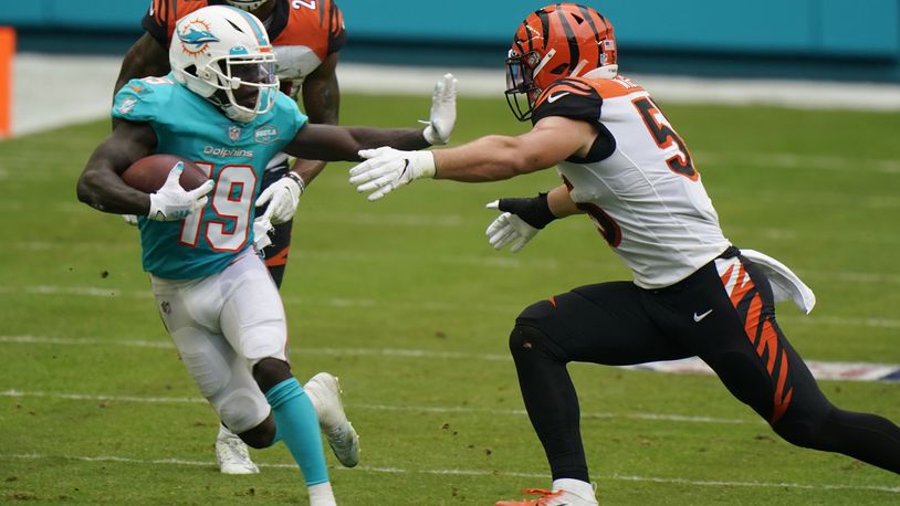 Miami Dolphins wide receiver Jakeem Grant (19) runs the football as Cincinnati Bengals linebacker Logan Wilson (55) attempts to tackle during the second half of an NFL football game, Sunday, Dec. 6, 2020, in Miami Gardens, Fla. (AP Photo/Wilfredo Lee)