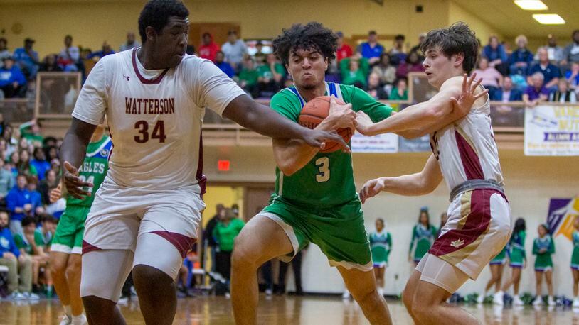Chaminade Julienne's George Washington III drives thought the defense of Columbus Watterson's Cole Rhett (34) and Owen Samenuk during the Eagles Division II region semifinal Thursday night at Butler High School. CONTRIBUTED/Jeff Gilbert