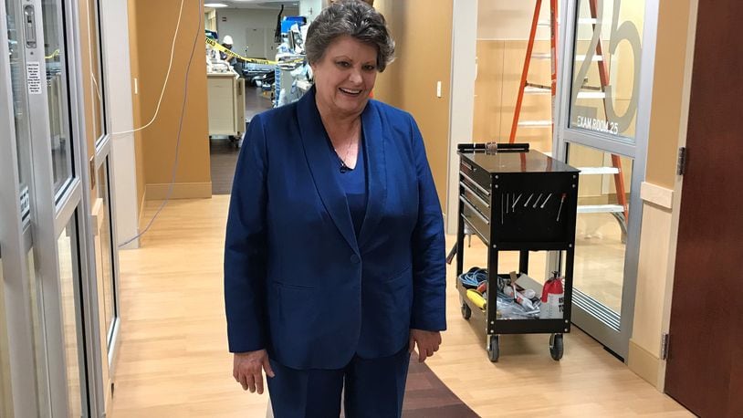 Grandview Medical Center president Becky Lewis stands in the emergency room at the Dayton hospital where construction workers are adding new patient rooms.