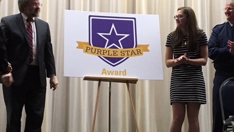 Paolo DeMaria, state superintendent for public instruction (left), and Zuza Livosky, then a Fairborn High School junior, unveiled the new Purple Star Award in 2017 at the National Museum of the U.S. Air Force. At far right is Maj. Gen. Mark E. Bartman, Ohio adjutant general. BARRIE BARBER/STAFF