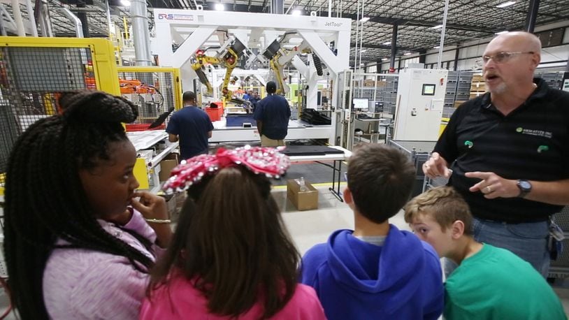 Northmont sixth grade students watch auto parts being made during a Manufacturing Day visit in 2018 to the automotive parts manufacturer Hematite that recently opened in Englewood.  Hematite makes under body shields, under engine covers and plastic wheel liners for auto manufacturers.   TY GREENLEES / STAFF