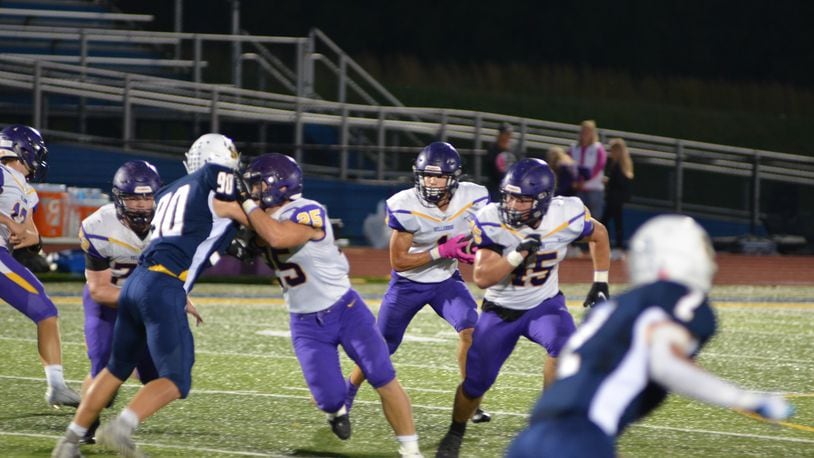 Bellbrook's Seth Borondy looks for room to run behind lead blockers Ashton Ault (25) and Nick Etienne (45) during Friday's game at Monroe. Eric Frantz/CONTRIBUTED