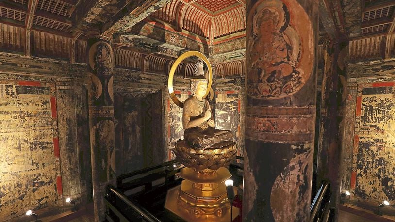 The interior of the first level of the three-story pagoda at Saimyoji temple in Kora, Japan. A seated Dainichi Nyorai Buddha statue in the center is surrounded by richly colored murals depicting the world of Buddha.  Yomiuri/Japan News photo.