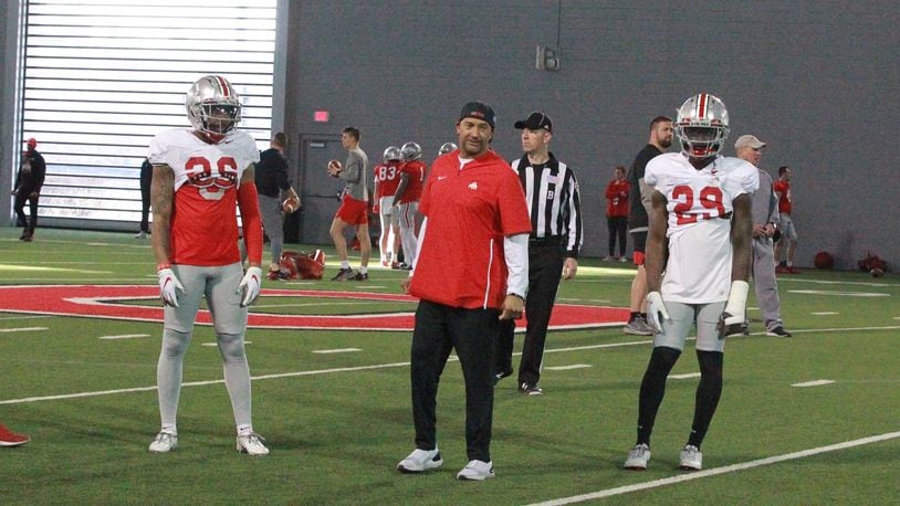 Ohio State football coach Tim Walton (middle) instructs cornerbacks at spring football practice March 29, 2021. With Cam Brown (left) and Denzel Burke (right).