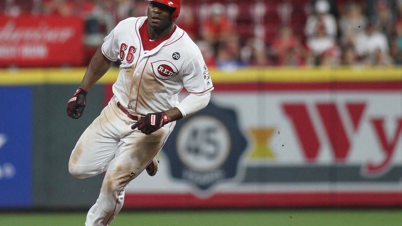 The Reds Yasiel Puig rounds the bases on his way to scoring the winning run in the 11th inning against the Brewers on Tuesday, July 2, 2019, at Great American Ball Park in Cincinnati. David Jablonski/Staff