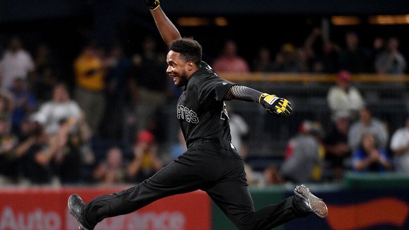 PITTSBURGH, PA - AUGUST 23: Pablo Reyes #15 of the Pittsburgh Pirates reacts as he rounds the bases after hitting a walk-off RBI single to left field giving the Pittsburgh Pirates a 3-2 win over the Cincinnati Reds at PNC Park on August 23, 2019 in Pittsburgh, Pennsylvania. Teams are wearing special color schemed uniforms with players choosing nicknames to display for Players' Weekend. (Photo by Justin Berl/Getty Images)