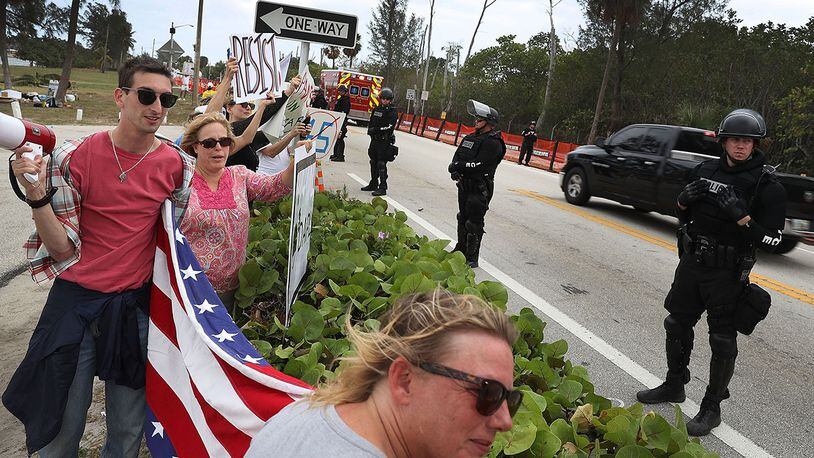 WEST PALM BEACH, FL - APRIL 06:  Protesters stand near the road as a convoy bearing Chinese President Xi Jinping was to drive past on his way to visit U.S. President Donald Trump at Mar-a-Lago April 6, 2017 in West Palm Beach, Florida. President Xi is in Florida to meet with President Donald Trump to discuss a range of sensitive issues including trade and North Korea.(Photo by Joe Raedle/Getty Images)