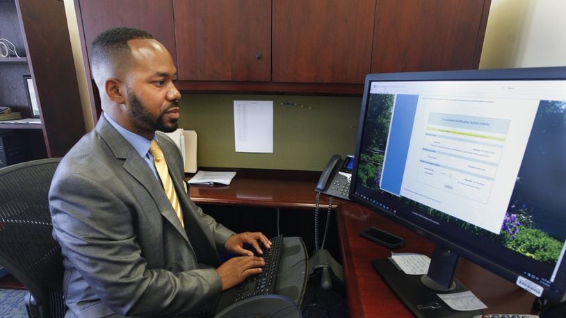 Montgomery County Recorder Brandon McClain demonstrates a fraud alert system that notifies enrolled property owners if changes are made to certain property records. This week the office rolled out a new system to accept documents filed online. CHRIS STEWART / STAFF