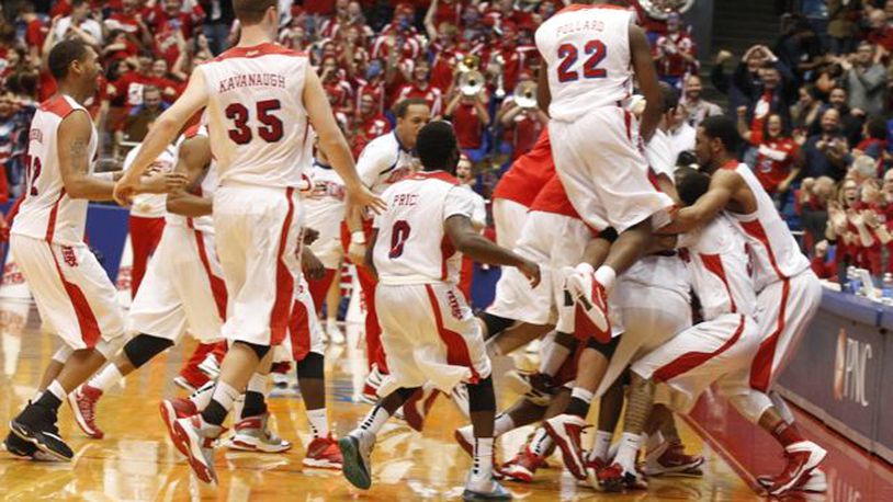 The Flyers celebreate after a 3-pointer by Jordan Sibert with 1 second left beat IPFW 81-80 on Saturday, Nov. 9, 2013, at UD Arena.