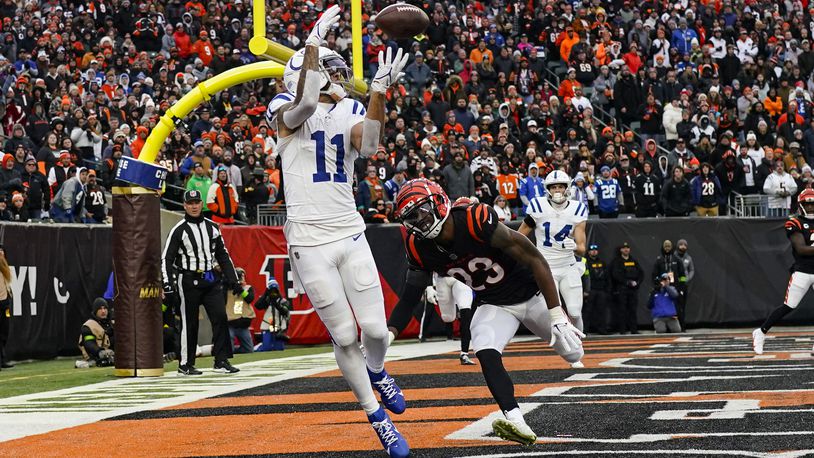 Indianapolis Colts wide receiver Michael Pittman Jr. (11) makes catch for a two-point conversion in front of Cincinnati Bengals safety Dax Hill (23) in the first half of an NFL football game in Cincinnati, Sunday, Dec. 10, 2023. (AP Photo/Carolyn Kaster)