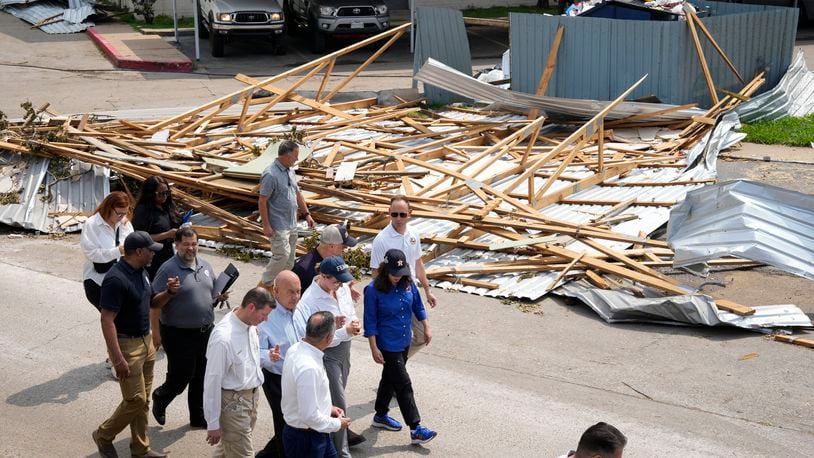 FEMA Administrator Deanne Criswell, blue FEMA hat, visits an apartment complex damaged by severe storms with Houston Mayor John Whitmire, to her right, and Harris County Precinct 4 Commissioner Lesley Briones, to her left, Tuesday, May 21, 2024, at Spring Branch in Houston. (Yi-Chin Lee/Houston Chronicle via AP)