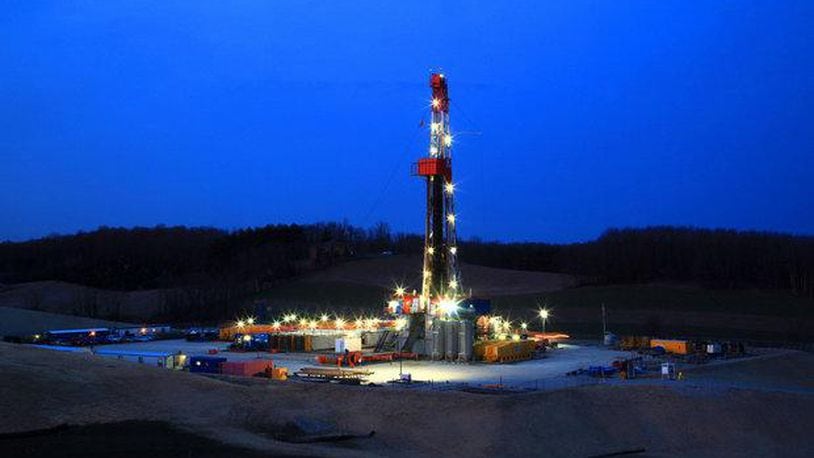 An oil drilling rig stands lit in Carroll County in 2013 when there was talk of an unstoppable shale “boom” in Ohio. Natural gas from shale wells was increasing at the time. Plain Dealer photo.