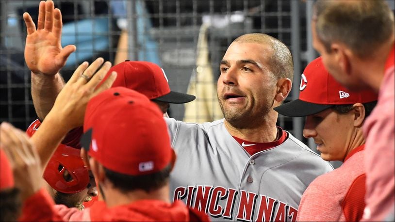 LOS ANGELES, CA - MAY 10:  Joey Votto #19 of the Cincinnati Reds is greeted in the dugout after scoring a run in the fourth inning of the game against the Los Angeles Dodgers at Dodger Stadium on May 10, 2018 in Los Angeles, California.  (Photo by Jayne Kamin-Oncea/Getty Images)