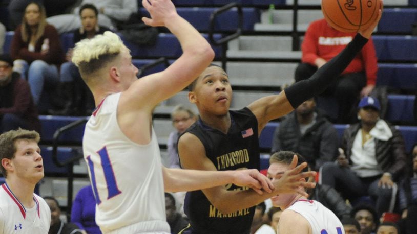 Mekhi Elmore (with ball) of Thurgood avoids Thomas Myers of Massie. Thurgood Marshall defeated Clinton-Massie 68-51 in a D-II boys high school basketball sectional semifinal at Trent Arena on Tuesday, Feb. 26, 2019. MARC PENDLETON / STAFF