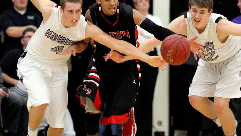 Lakota East guard Robbie Harpring (left), Lakota West guard Tyler Williams (middle) and East forward Alex White (right) chase a loose ball during a game in Liberty Township on Jan. 8, 2013. JOURNAL-NEWS FILE PHOTO