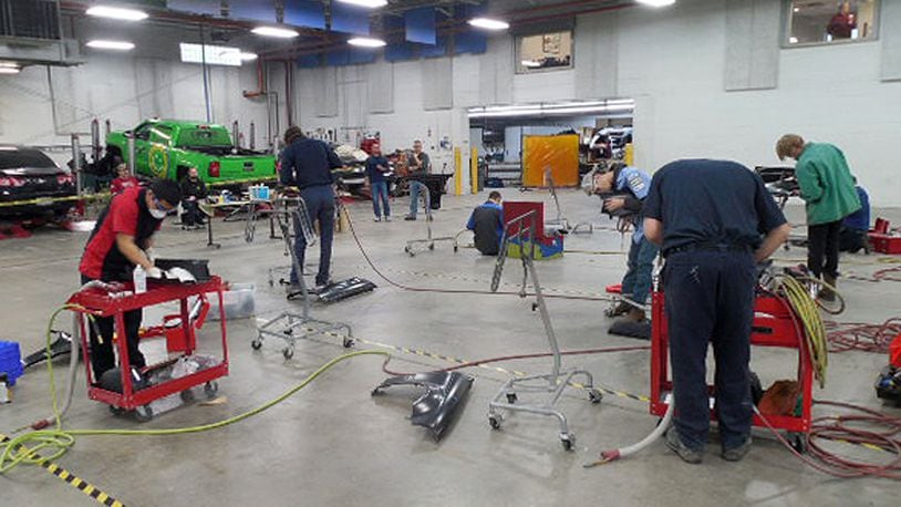 Career tech students work on collision repair at the Voss Collision Center in February during the regional SkillsUSA competition. Contributed photo by Mike Moore