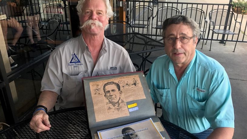 Kevin O Donnel (left) and Doug Spatz (right) with the treasured scrapbook of their great uncle Norb Sacksteder, one of the early superstars of the fledgling NFL and before that the pre-NFL pro game and the college game (including the University of Dayton). Tom Archdeacon/STAFF