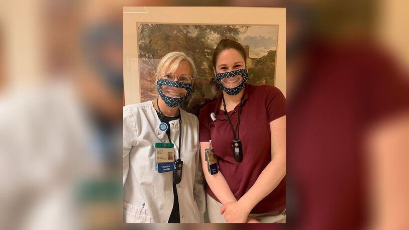 Two Atrium Medical Center speech therapists, from left, Tracey Wells and Katie Hanak wear special masks that were donated by Diana Unger. The masks allow a person with hearing disabilities to read lips. SUBMITTED PHOTO
