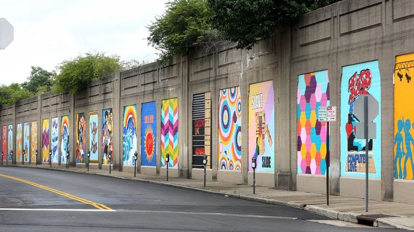 “Land of Funk,” a mural of 21-panels, has been painted along the Stone Street railroad wall. LISA POWELL / STAFF