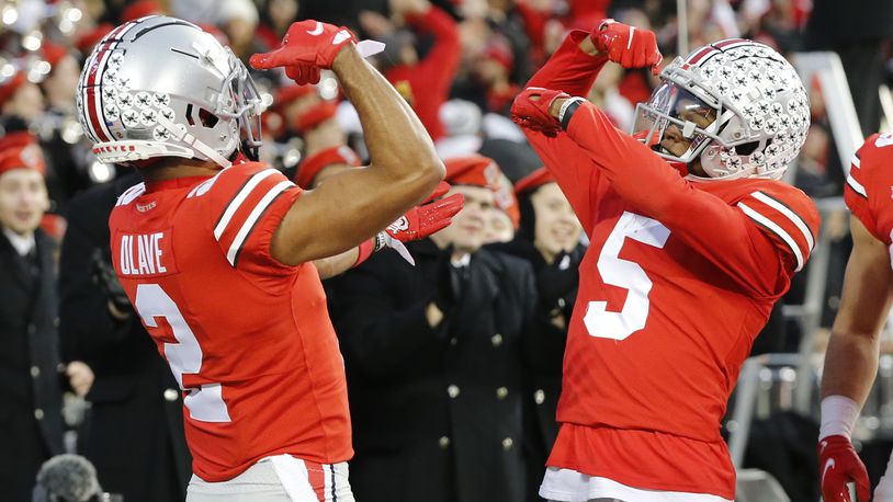 Ohio State receiver Garrett Wilson, right, celebrates his touchdown against Purdue with teammate Chris Olave during the first half of an NCAA college football game, Saturday, Nov. 13, 2021, in Columbus, Ohio. (AP Photo/Jay LaPrete)