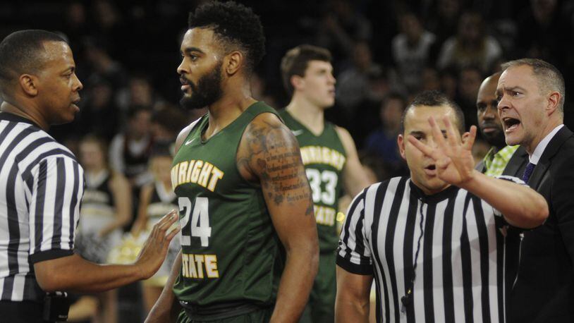 Referee Edwin Young (left), a former University of Dayton standout, addresses a personal foul with Mark Alstork of Wright State while Raiders coach Scott Nagy (right) also has a say. WSU played at Oakland (Mich.) in a Horizon League opener on Thursday, Dec. 29, 2016. MARC PENDLETON / STAFF