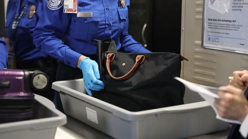 A Transportation Security Administration (TSA) worker screens luggage. The TSA  said Wednesday that workers at security checkpoints at Atlanta's Hartsfield-Jackson International Airport have found more loaded guns again this year in baggage than at any other U.S. airport.