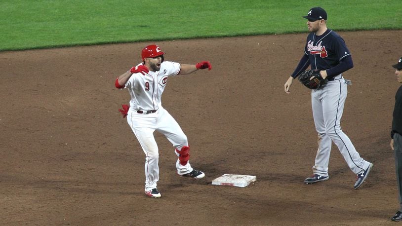 The Reds’ Jose Peraza celebrates after a two-run double in the sixth inning on Tuesday, April 23, 2019, at Great American Ball Park in Cincinnati.