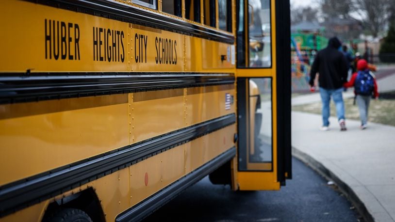 Students at Wright Brothers Elementary head to the bus for a ride home Tuesday December 13, 2022. Schools across the region are still struggling to cover bus routes including Huber Heights schools. JIM NOELKER/STAFF