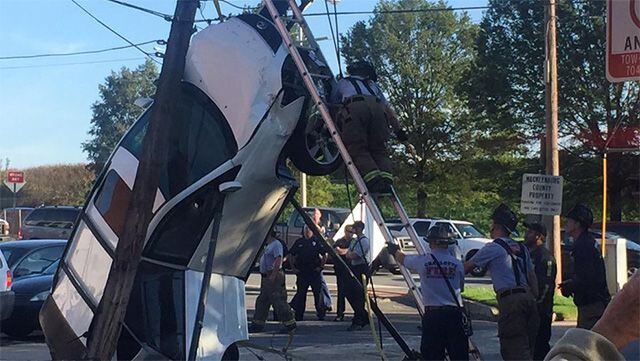 Car crashes up power pole in uptown
