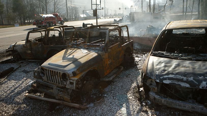 GATLINBURG, TN - NOVEMBER 29: The remains of a Jeep rental business smolders after a wildfire November 29, 2016 in Gatlinburg, Tennessee. Thousands of people have been evacuated from the area and over 100 houses and businesses were damaged or destroyed after drought conditions helped the fire spread through the foothills of the Great Smoky Mountains. (Photo by Brian Blanco/Getty Images)