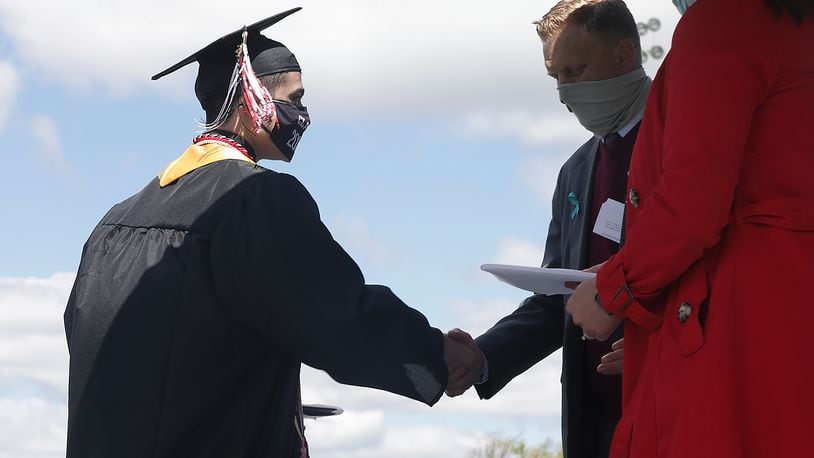 Greenon High School held their 2021 Commencement Ceremony Saturday. Over a 100 graduates, sitting six feet apart and all wearing masks, participated in the ceremony at the school's statium. Greenon is the fist school in the area to hold a 2021 commencement ceremony. BILL LACKEY/STAFF
