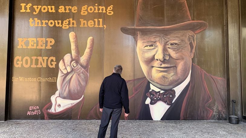 Winston Churchill, prime minister of Great Britain during much of World War II, is the subject of the latest downtown Dayton mural on the Stratacache Tower. The image of Churchill, painted by mural artist Erica Arndts, is accompanied by a quote he is associated with, âIf you are going through hell, keep going.â LISA POWELL / STAFF