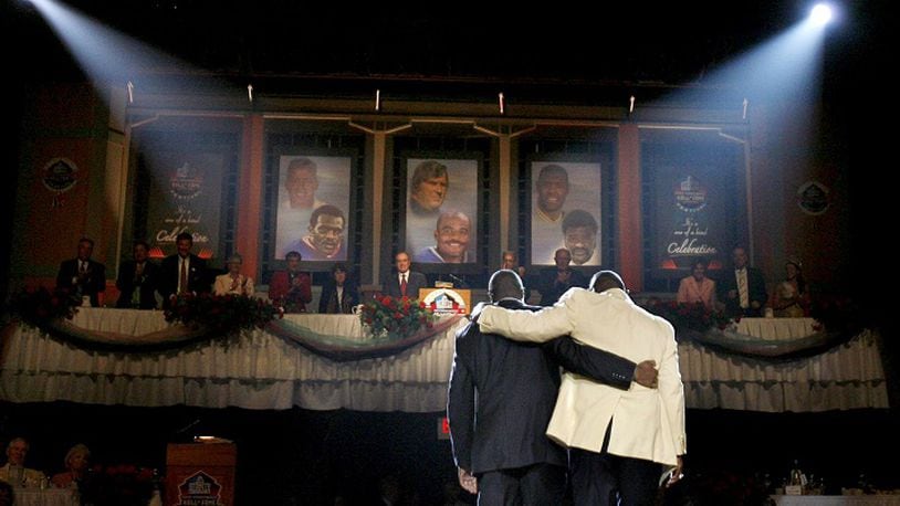 After receiving his blazer from his son Donald Carson, New York Giants' Harry Carson walks arm-in-arm with his son off stage during ceremonies at the Enshrinement Dinner in Canton, Ohio on Friday, August 4, 2006. (Louis DeLuca/Dallas Morning News/TNS)NO MAGAZINE SALES MANDATORY CREDIT; NO SALES; INTERNET USE BY TNS CONTRIBUTORS ONLY