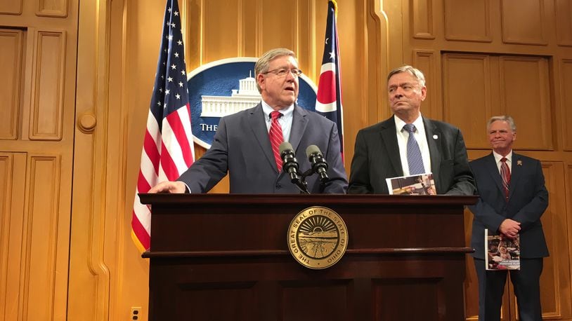 State Representatives Bob Cupp (left) and John Patterson describe a new school funding proposal Monday, March 25, at the Ohio Statehouse. LAURA A. BISCHOFF / STAFF