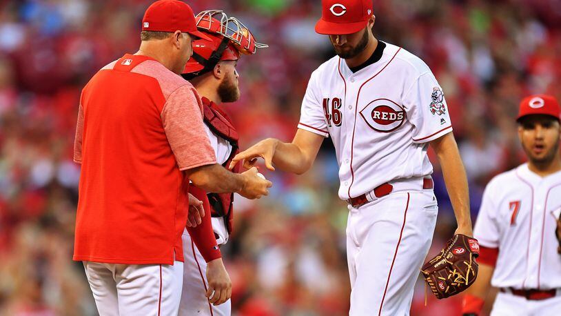 CINCINNATI, OH - JULY 14:  Pitcher Tim Adleman #46 of the Cincinnati Reds hands the ball to manager Bryan Price #38 of the Cincinnati Reds after being pulled in the fifth inning against the Washington Nationals at Great American Ball Park on July 14, 2017 in Cincinnati, Ohio. Washington shut out Cincinnati 5-0.  (Photo by Jamie Sabau/Getty Images)