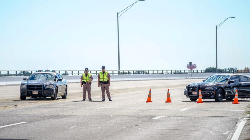 Florida State Troopers block traffic over the Bayou Grande Bridge leading to the Pensacola Naval Air Station following a shooting Friday in Pensacola, Fla. The second shooting on a U.S. Naval Base in a week has left three dead plus the suspect and seven people wounded. (Photo by Josh Brasted/Getty Images)