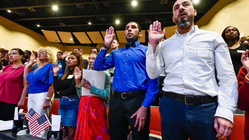 Abbas MR Almukahal, right, from Palestine, and Abbas Musafer Ajmi Jasmie, from Iraq, were among the 99 people who became U.S. citizens during a naturalization ceremony Monday, Sept. 17 at Miami University Hamilton’s Parrish Auditorium in Hamilton.