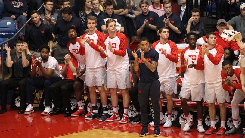 Dayton players, including Kyle Davis, center, and Josh Cunningham, far left, cheer from the bench during a game against Saint Louis on Jan. 22, 2017, at UD Arena. David Jablonski/Staff